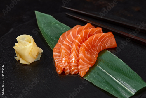 Japanese food style, Top view of salmon slice on bamboo leaves, Salmon sashimi is Japanese traditional, Selective focus, Fish slices top view