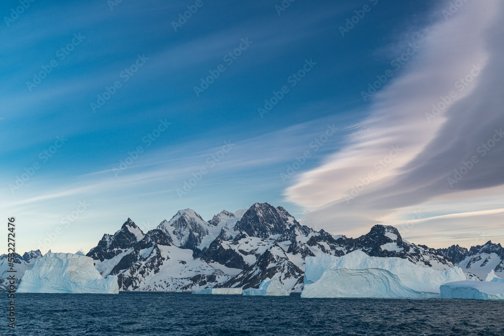 South Georgia Island. Landscape of Icebergs, mountain, curved clouds and ocean.