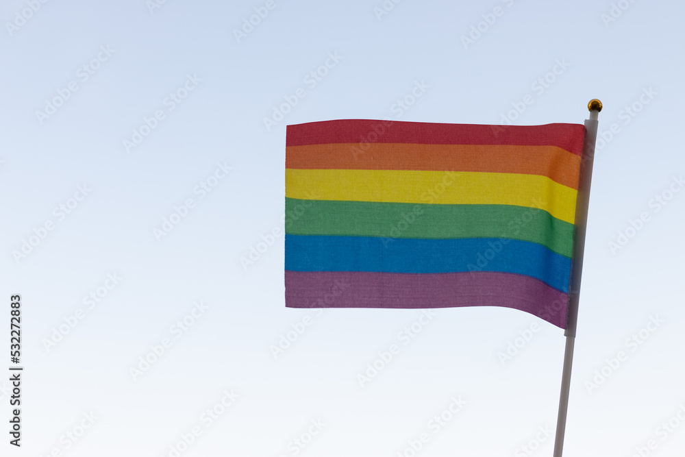 Obraz premium Rainbow flag, a symbol of the LGBT community, waving in the wind on a cloudy background Gay flag