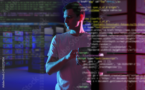 Data science. Man Data Science Specialist. Guy with tablet works in IT. Data science specialist is holding tablet. Information processing. Servers with neon light behind man. Blurred program code