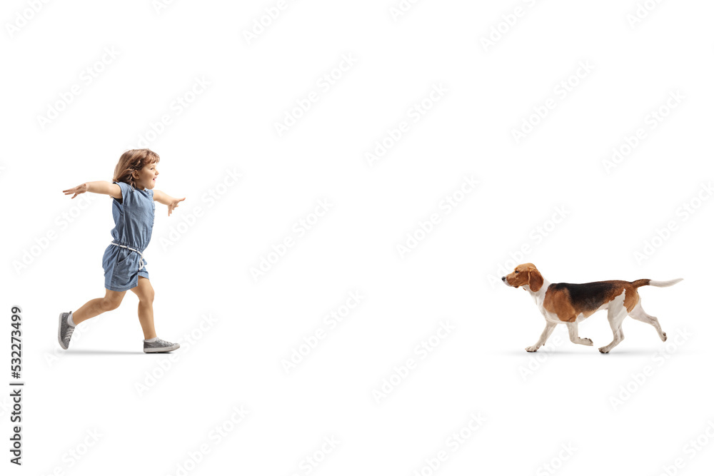 Full length profile shot of a happy little girl running to hug a dog Full length profile shot of a happy little girl running to hug a dog