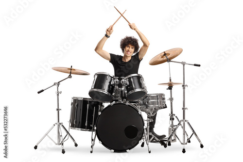 Fototapete Young male drummer holding drumsticks up