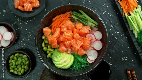 Super Slow Motion Shot of Fresh Salmon Cuts Falling into Poke Bowl at 1000fps.