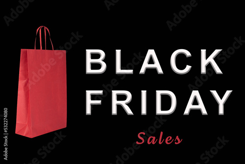 Black Friday Sales Sign and a red paper bag in a black background