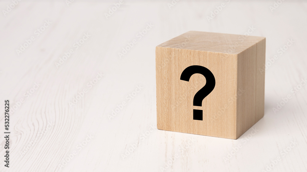 wooden block with black question mark on white wooden table background, business teamwork concept wooden block with black question mark on white wooden table background, business teamwork concept