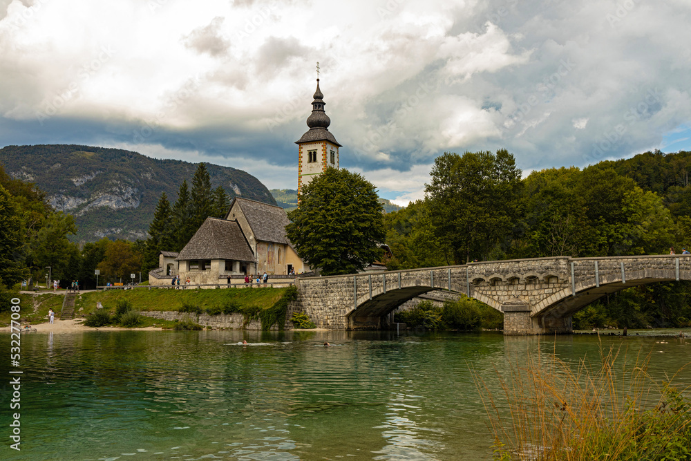 Bohinj lake bridge and church of St. John the Baptist in Ribčev Laz in Slovenia