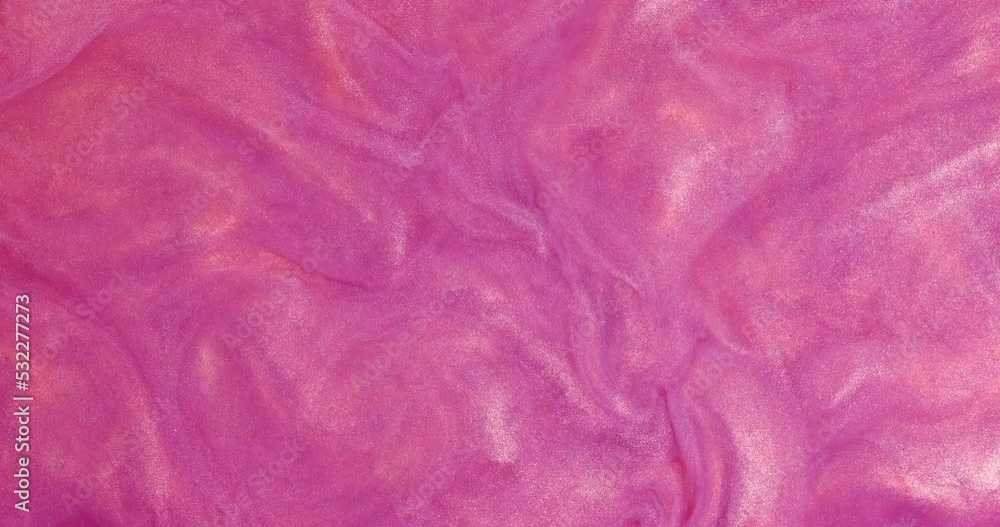 Liquid acrylic paints spread and mix, forming an abstract background. Liquid acrylic paints spread and mix, forming an abstract background.