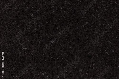 Black background. The texture of the asphalt.
