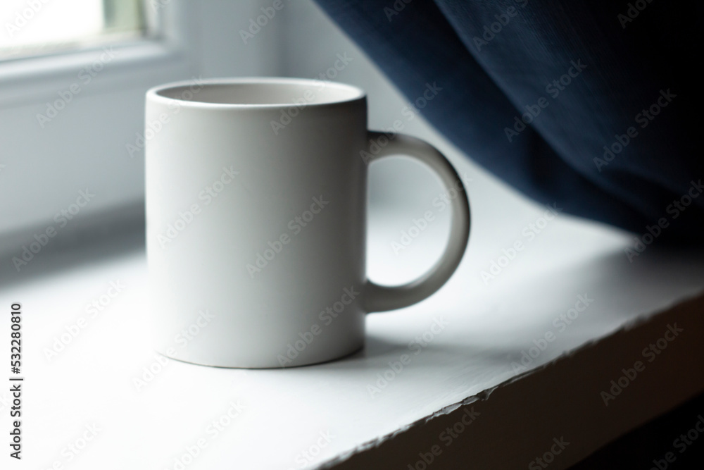 White mug on the windowsill