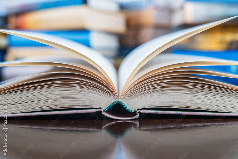 Closeup opened book on library desk Closeup opened book on library desk