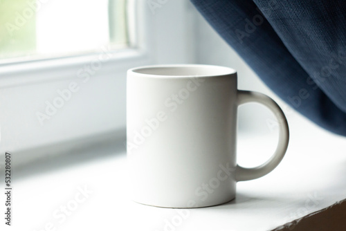 White mug on the windowsill