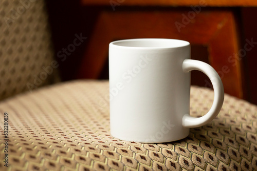 Obraz na płótnie White mug on the chair w salonie