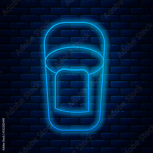 Glowing neon line Bucket with rag icon isolated on brick wall background. Cleaning service concept. Vector