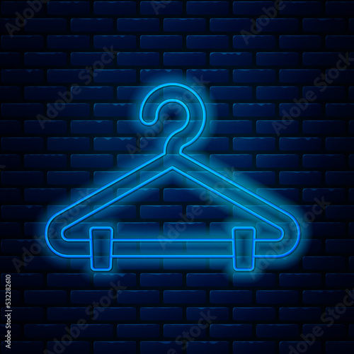 Glowing neon line Hanger wardrobe icon isolated on brick wall background. Cloakroom icon. Clothes service symbol. Laundry hanger sign. Vector