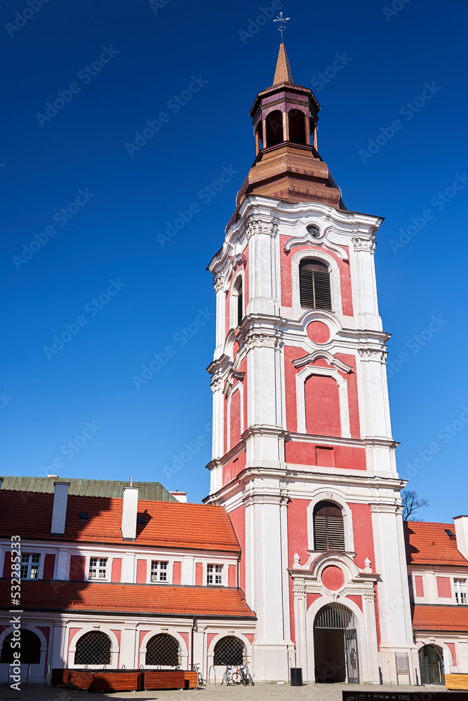 baroque buildings with belfry of a former monastery on a sunny day