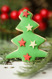 Christmas decoration. Christmas tree branches and homemade decorated Christmas cookies, close up image.	