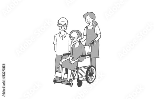 車椅子を押す女性と介護士