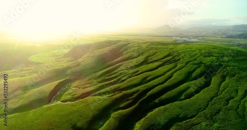 Amazing view of sun shining over beautiful green landscape in Iceland.