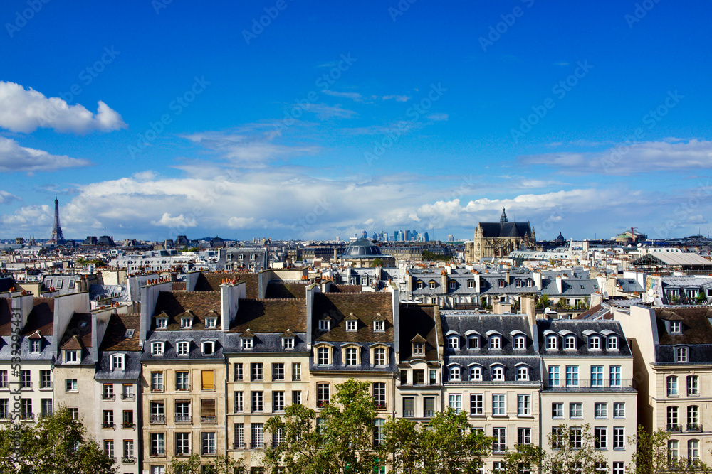 France, Paris. Houses facing Beaubourg, Centre Pompidou square, Eiffel tower on the far left