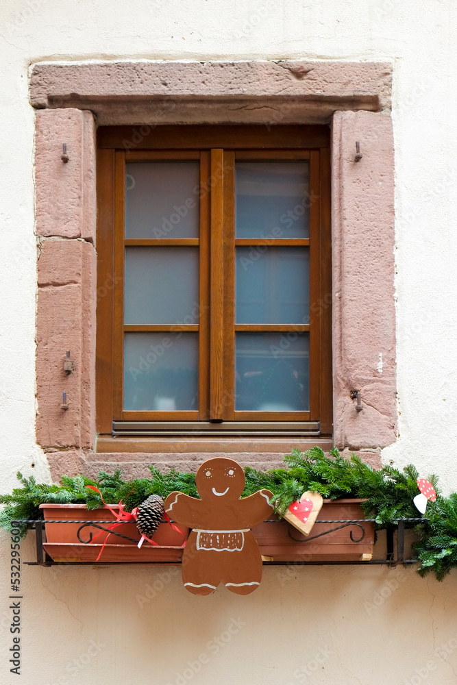 Riquewihr, France. Village established in the 1400's in the Alsace Region. Window decorated with Christmas ornaments.