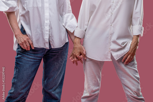 Close up of two women standing hand in hand