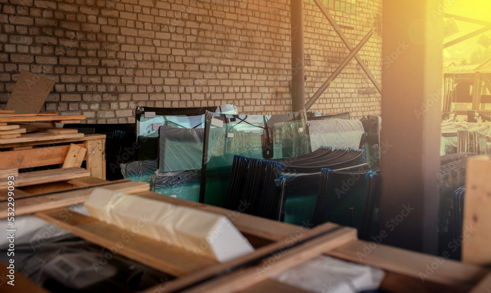 warehouse with new glasses for cars, windshields in wooden containers.