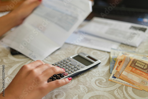 Housewife woman calculate energy invoice bills costs,family expenses price crisis