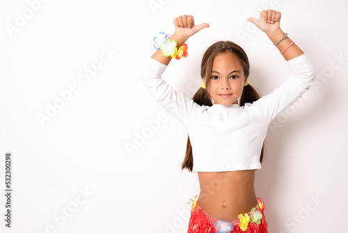 little child girl in hawaiian costume showing thumbs up isolated white background