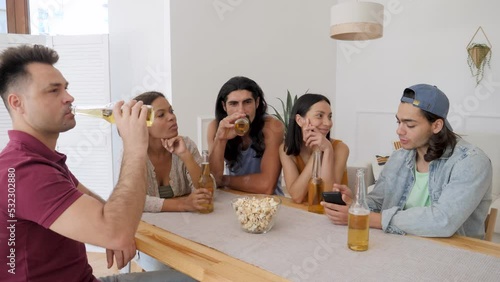 Wallpaper Mural the guy looks at the phone and tells the girl, surrounded by friends, an interesting funny story Torontodigital.ca