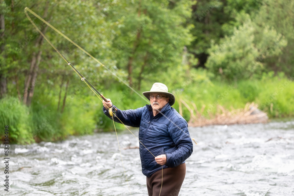 An older man tries his luck at fly fishing for salmon. Russian River. Cooper Landing, Alaska. An older man tries his luck at fly fishing for salmon. Russian River. Cooper Landing, Alaska.