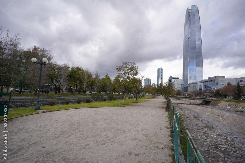 Cityscape during grey winter day, Santiago, Chile. Costanera skycraper on background, Mapocho river at first ground