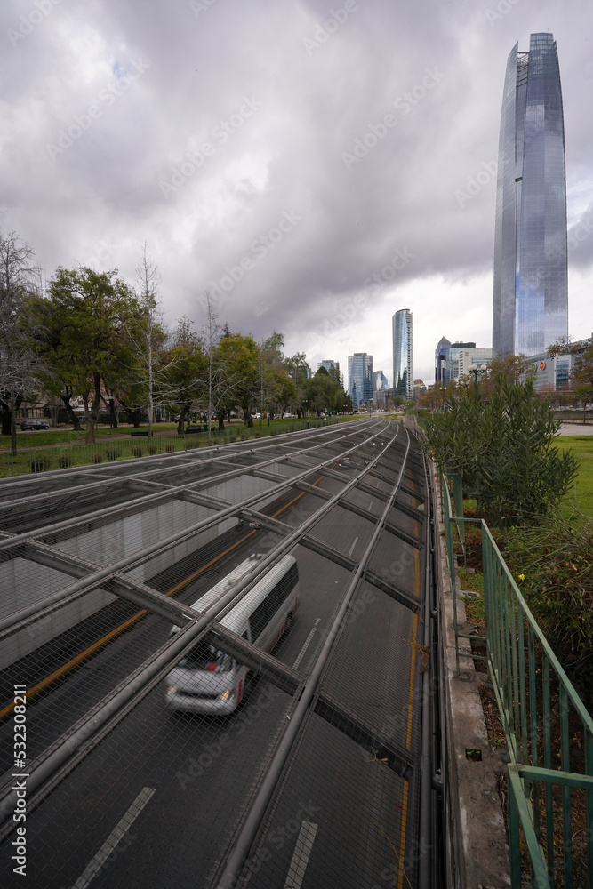 Car passing on a highway, Costanera center skycraper on the background, Santiago, Chile 