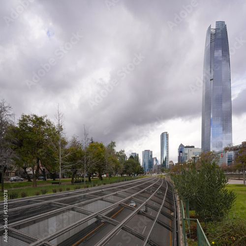 Traffic on highway in front of Costanera center in Santiago, Chile during stormy winter day 