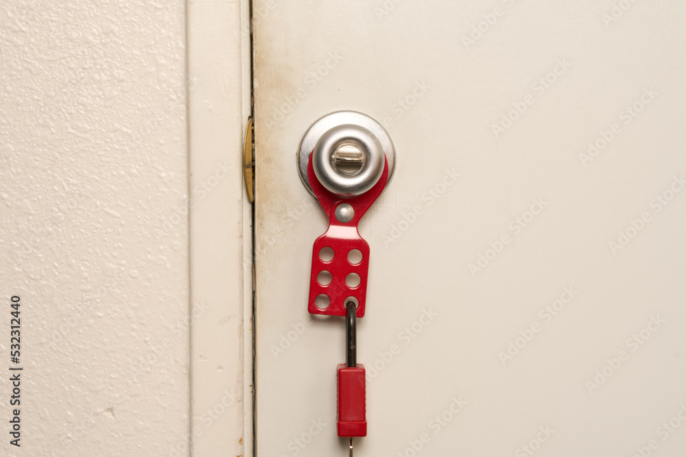 lockout/tagout attached to doorknob with lock attached Stock Photo ...