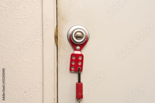 lockout/tagout attached to doorknob with lock attached photo