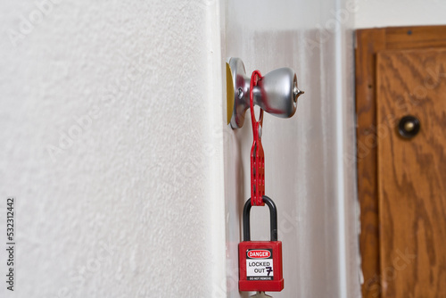 lock attached to lockout/tagout fixed to doorknob