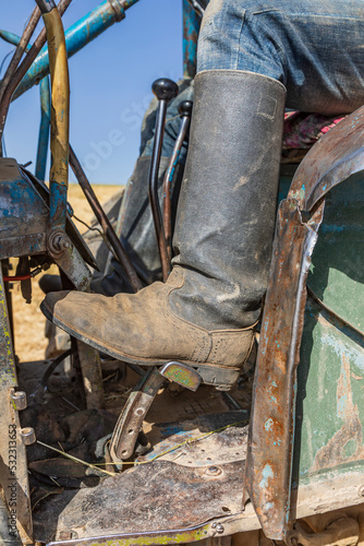 Shagmon, Khatlon Province, Tajikistan. Boot on the controls of a farm tractor during harvest.