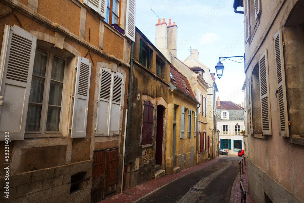 Fototapeta premium View of old narrow streets of French city of Auxerre in autumn day..