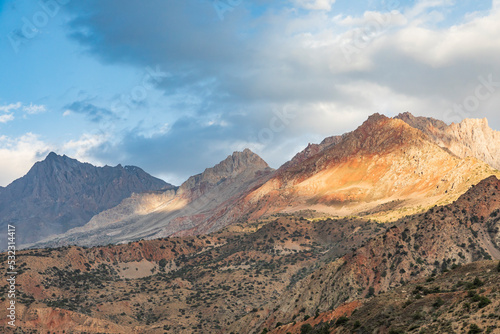 Iskanderkul, Sughd Province, Tajikistan. Sunshine on mountains near Iskanderkul Lake. © Danita Delimont