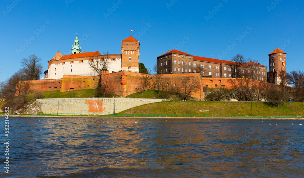 Scenic view of fortified architectural complex of Wawel Castle on Vistula river bank on spring day