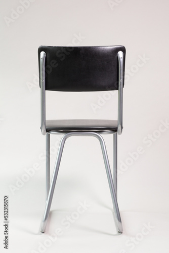 Vintage chair seen from behind on grey background photo