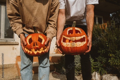 Funny halloween pumpkins in hands photo