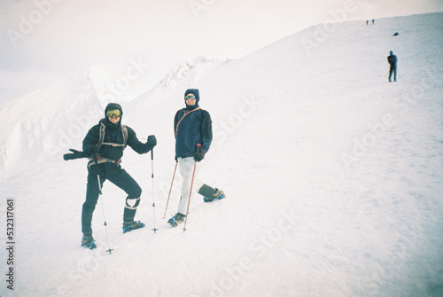 Hikers exploring mountains in blizzard