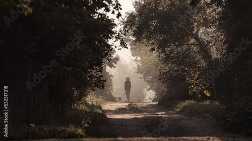 A young girl who went out for a foggy walk with her pet in the early summer morning