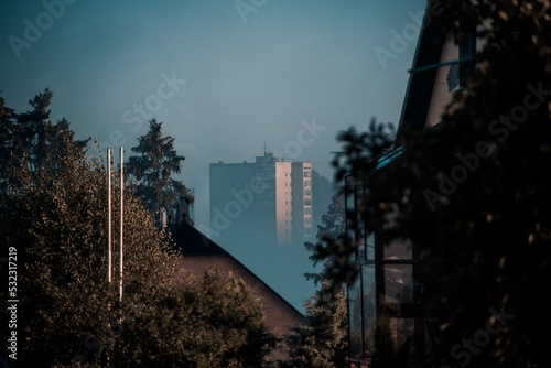 Morning fog covering the base of a multi-storey building, early sunrise
