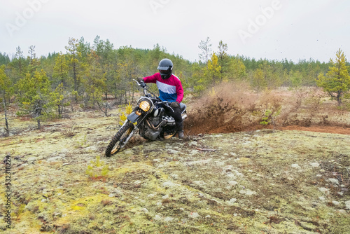 Man in a beautiful outfit rides through the forest photo