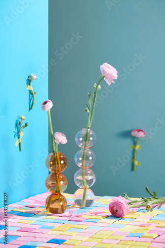 pink persian buttercup isolated in the glass vase on the table