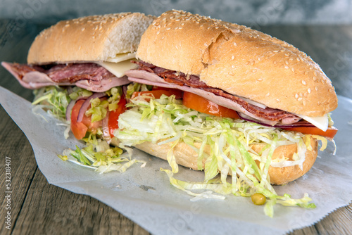Lunch is served with a loaded Italian sub sandwich overflowing with meat, veggies, and romaine lettuce