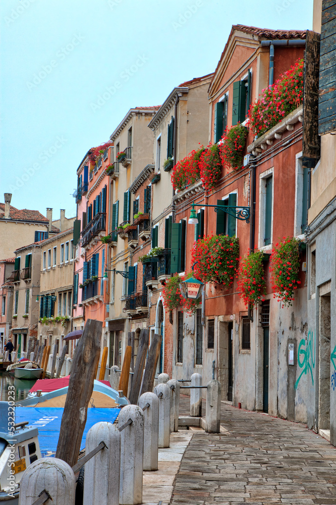 Italy, Venice. Street along the canal in Venice.