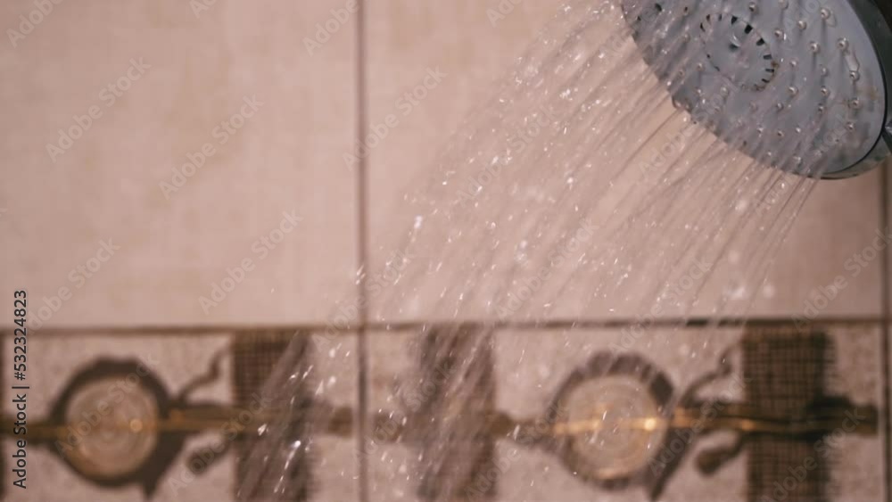 Vidéo Stock Woman's hand holds a shower in the bathroom from which